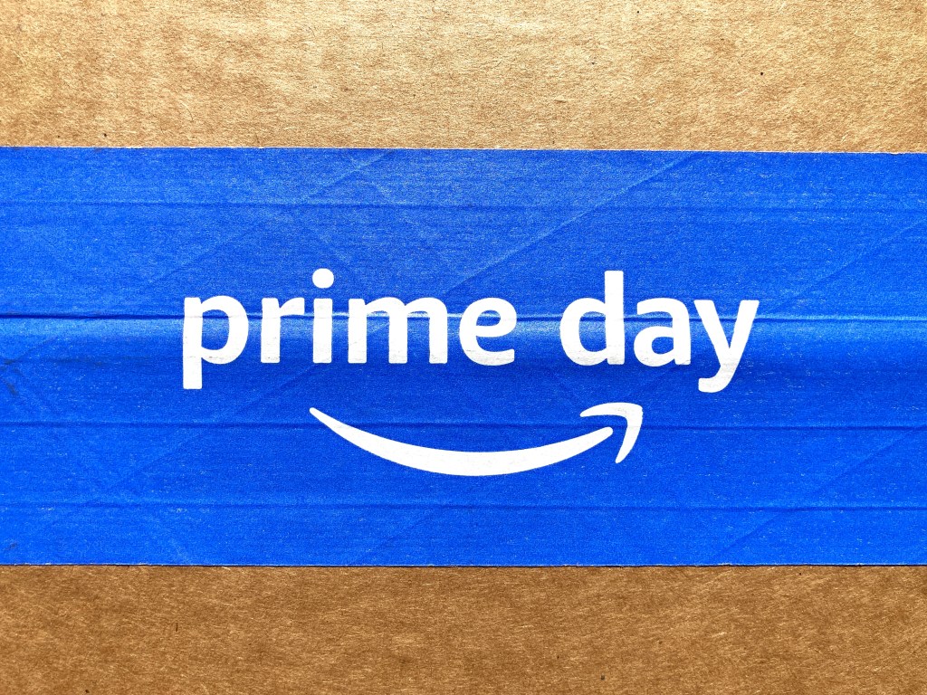 Amazon Prime Day sign and logo displayed on the blue strip of a cardboard box, advertising an exclusive event for Amazon.com Prime members in Seattle, Washington, USA, 2022